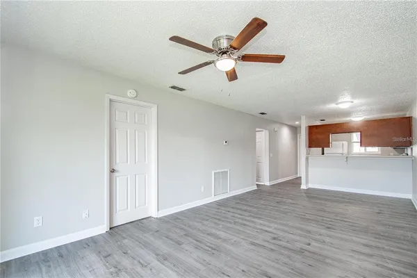 a view of an empty room and wooden floor
