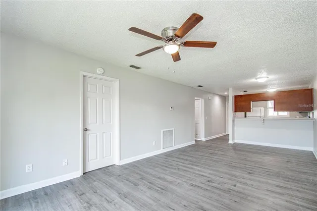 a view of an empty room and wooden floor