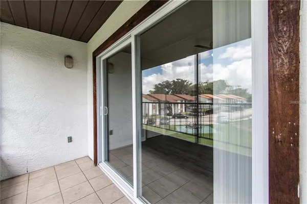 a view of a glass door and a balcony