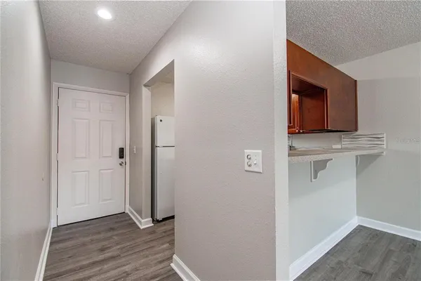 a view of hallway with wooden floor