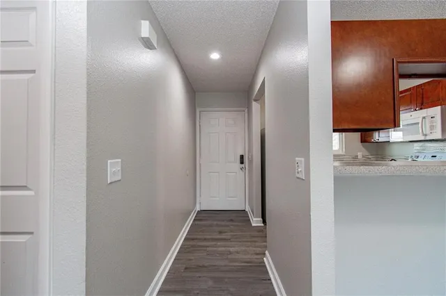 a view of a hallway with wooden floor