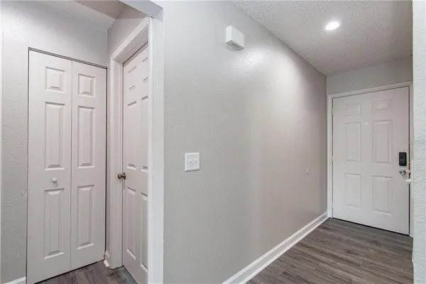 a view of a hallway with wooden floor