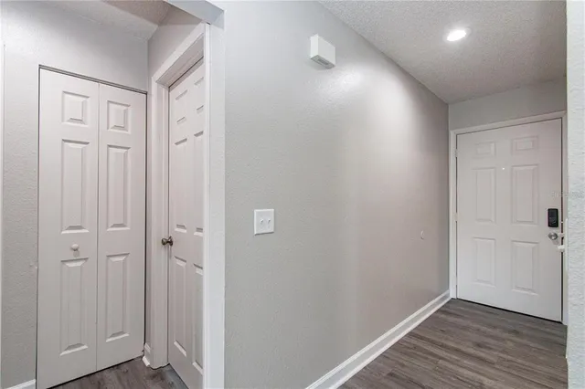 a view of a hallway with wooden floor