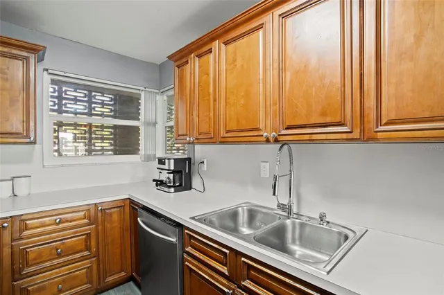 a kitchen that has a sink a stove and a window
