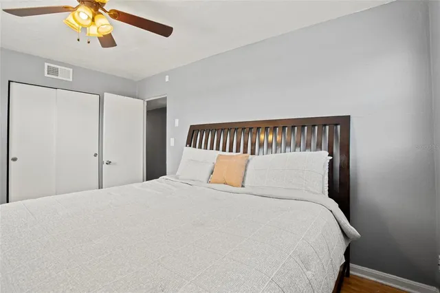 a large bed sitting in a bedroom and a chandelier