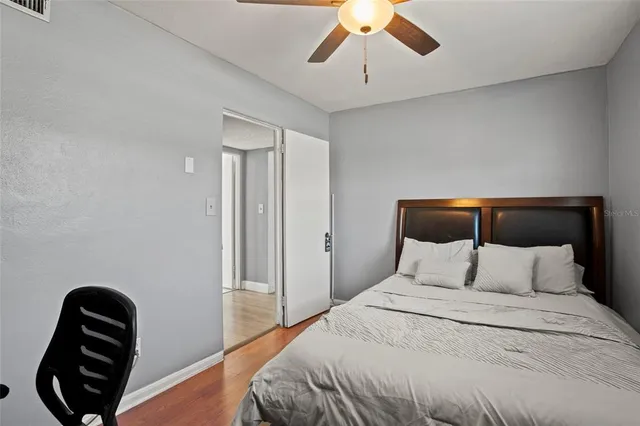 a bedroom with a bed and a chair