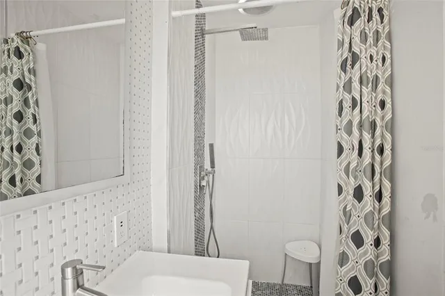 a bathroom with a toilet and shower curtain