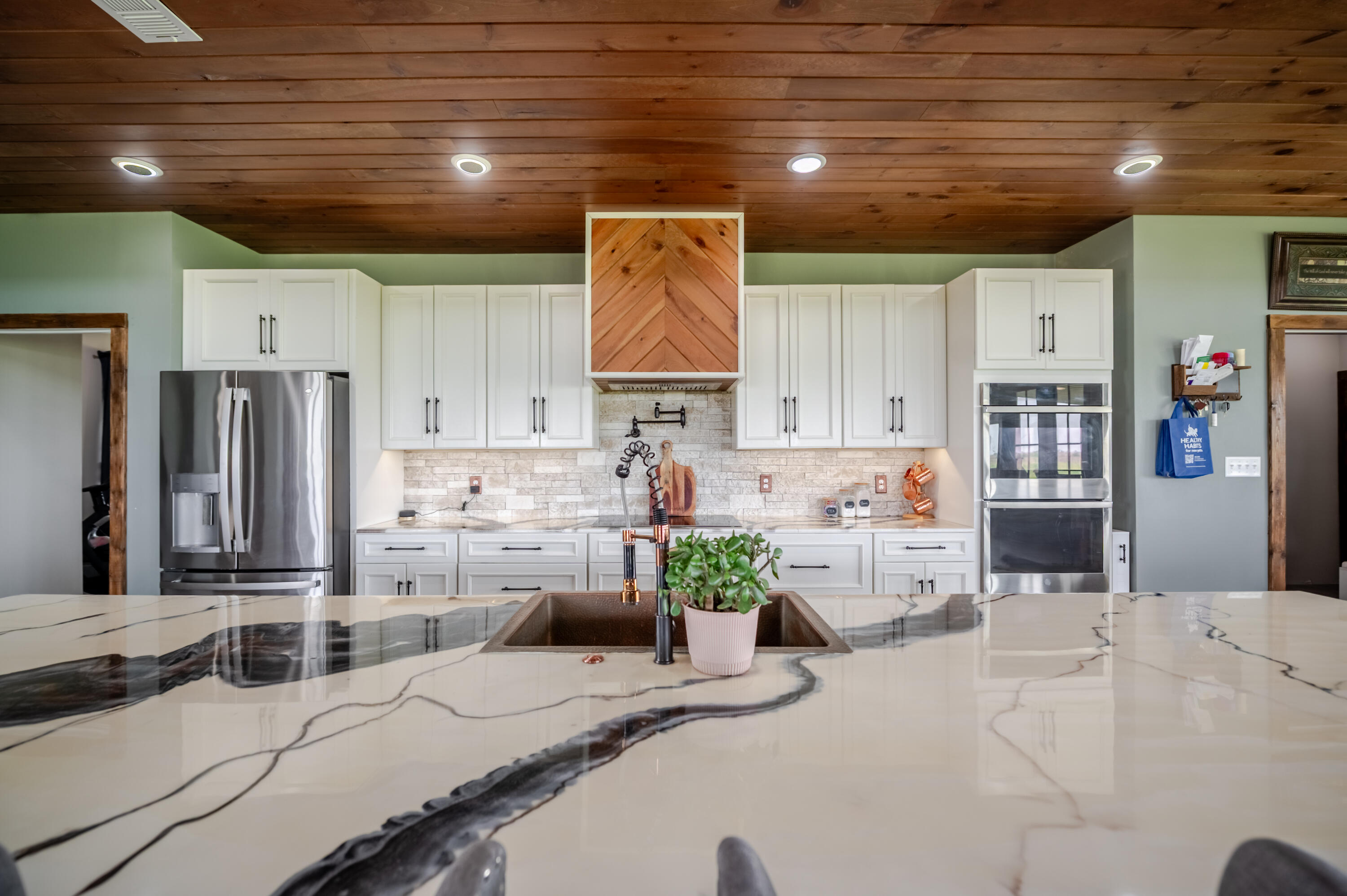 6792 Maine Road Anton, TX 79313 - Photo 14 of 77 a kitchen with stainless steel appliances kitchen island granite countertop a sink and cabinets