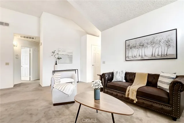 a living room with furniture and a painting