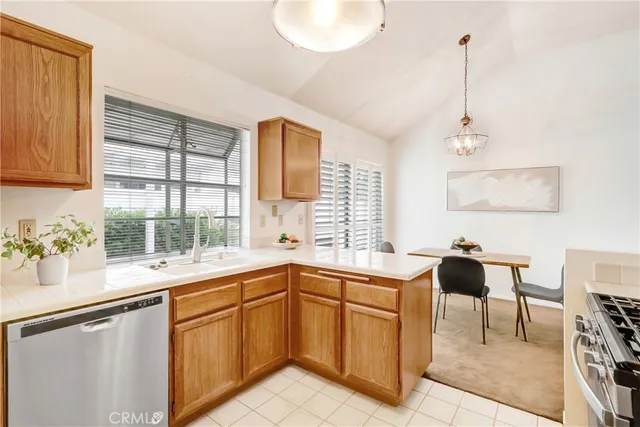 a kitchen with a sink and large windows