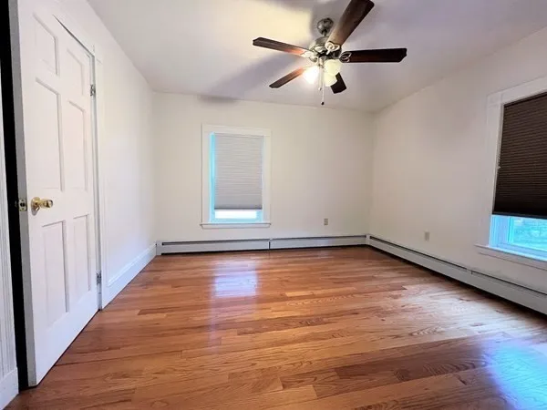 wooden floor in an empty room with a window