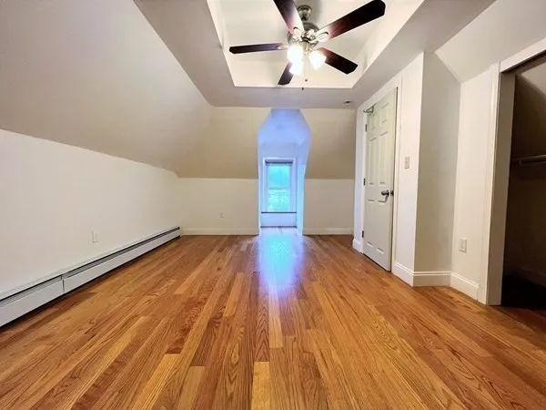 a view of empty room with wooden floor