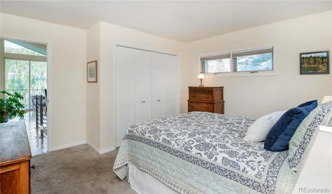 a bedroom with a bed and a potted plant