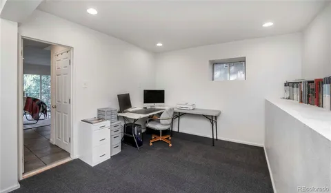a view of a workspace with furniture and a cabinet