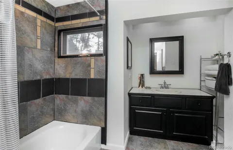 a bathroom with a sink a toilet and mirror