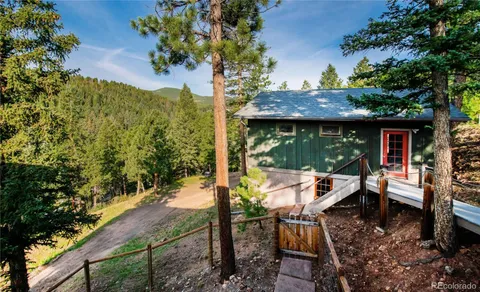 a view of a patio with table and chairs and potted plants
