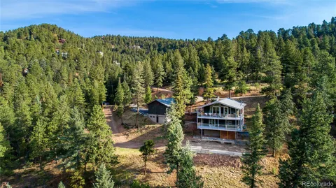 a view of a house with a mountain yard