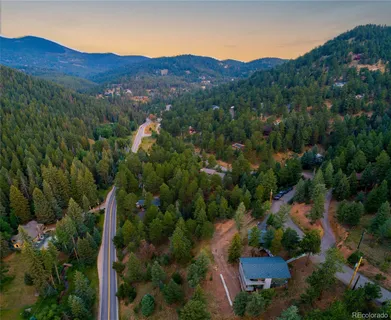 an aerial view of residential house and sandy dunes