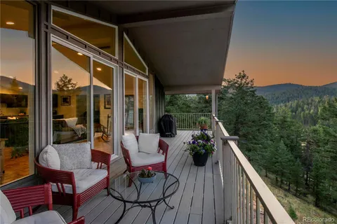 a balcony with furniture and wooden floor