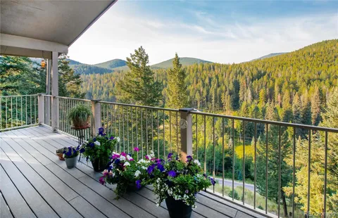 a view of a balcony with flower plants
