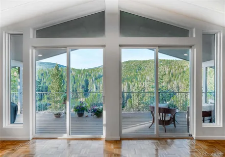 a view of a living room and floor to ceiling window