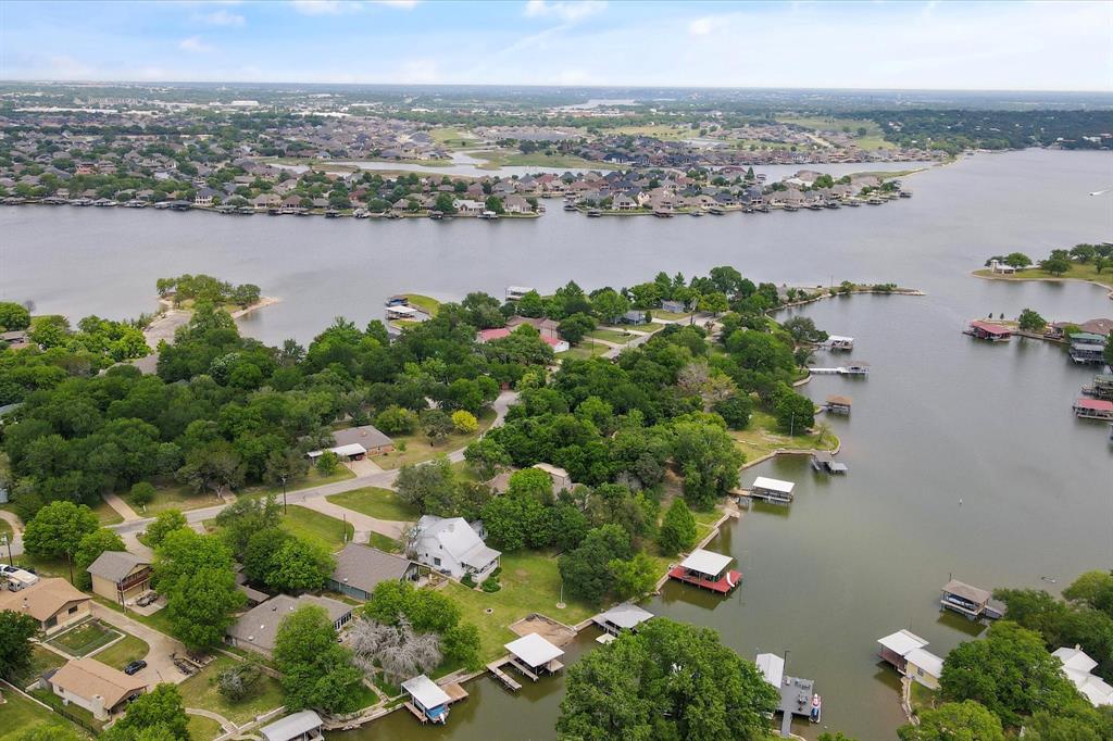 an aerial view of lake and residential houses with outdoor space