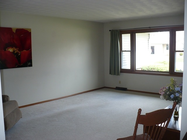 1230 Springdale Drive Rochelle, IL 61068 - Photo 3 of 22 a view of a room that has a window and wooden floor