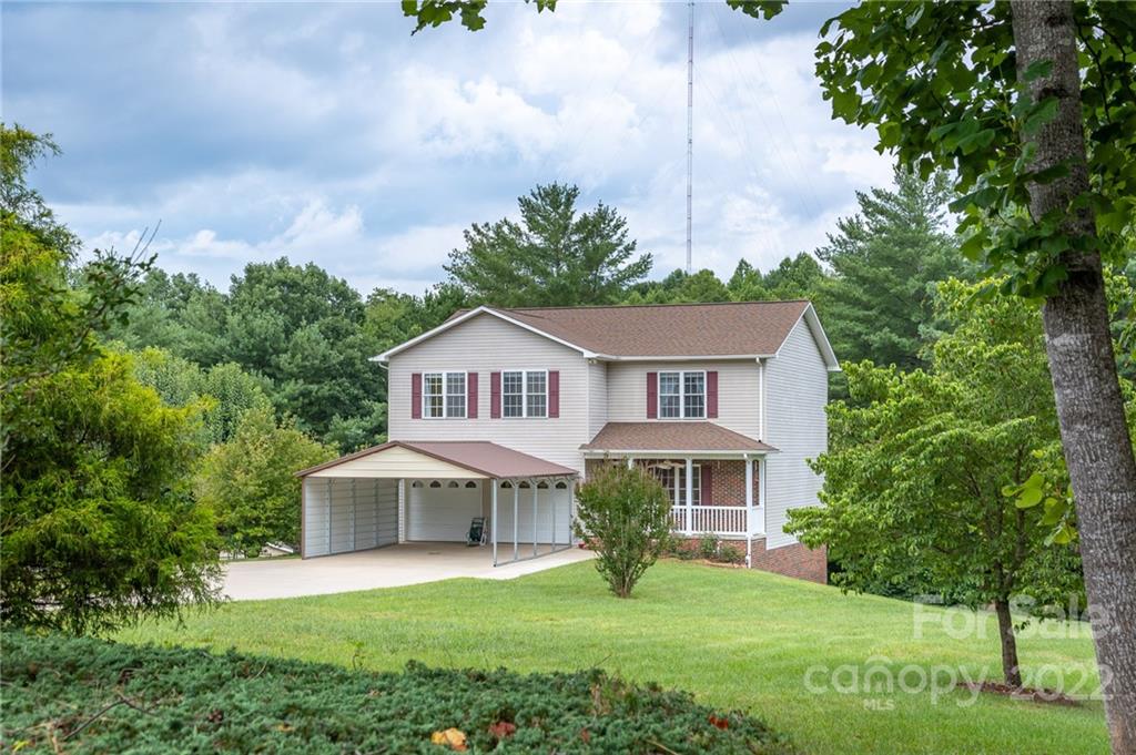 3446 Raintree Drive Hudson, NC 28638 - Photo 1 of 24 a front view of a house with yard and green space