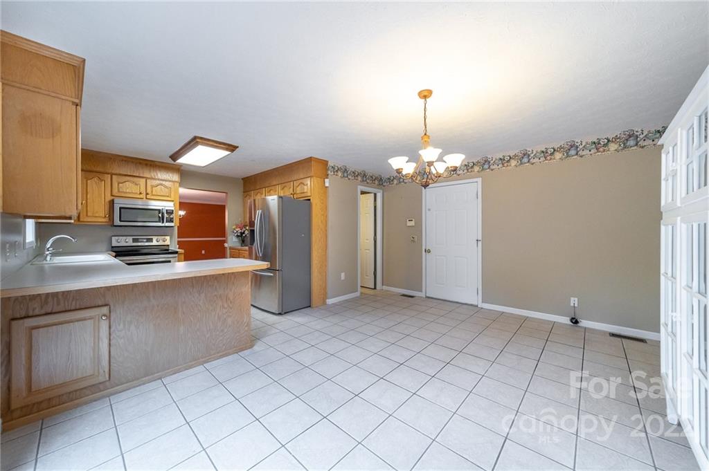 3446 Raintree Drive Hudson, NC 28638 - Photo 8 of 24 a view of a kitchen with a sink cabinets and a window