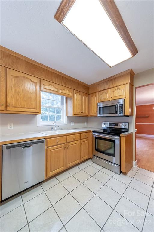 3446 Raintree Drive Hudson, NC 28638 - Photo 9 of 24 a kitchen with stainless steel appliances granite countertop a stove a sink and a microwave