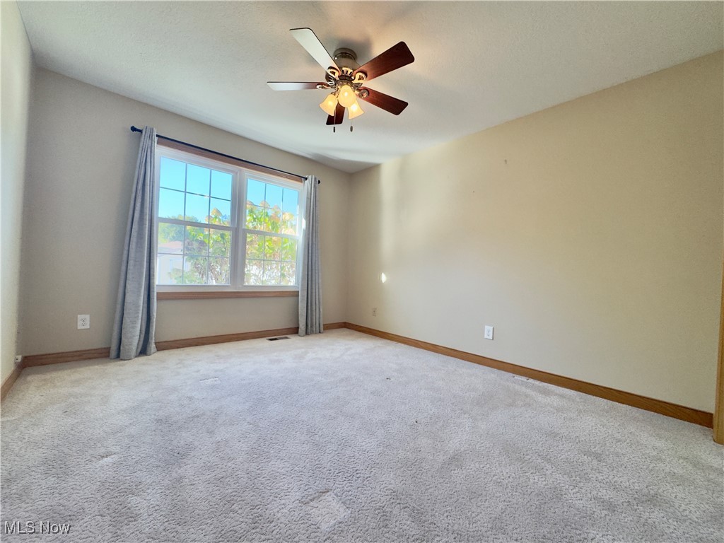 6014 Wentworth Road Southwest Canton, OH 44706 - Photo 13 of 22 Bedroom with light colored carpet and a ceiling fan