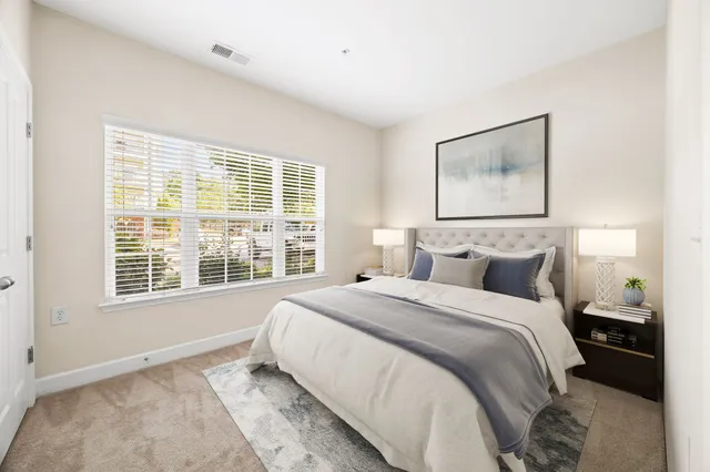 a bedroom with a bed and a window