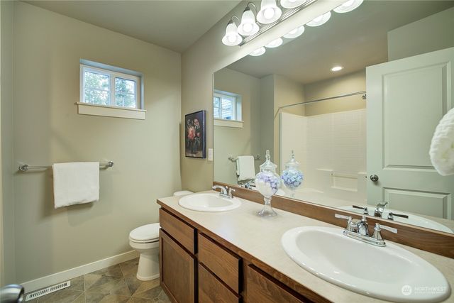 a bathroom with a toilet a sink and a mirror