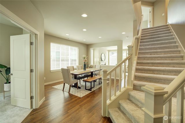a view of a livingroom with furniture wooden floor and windows