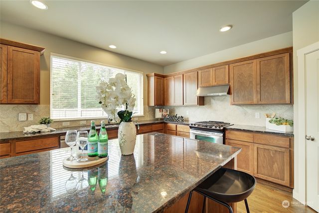 a kitchen with a table chairs stove and kitchen island
