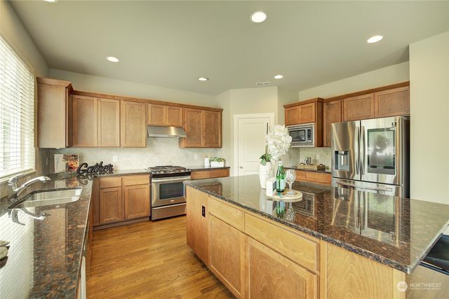 a kitchen with a sink stove and refrigerator