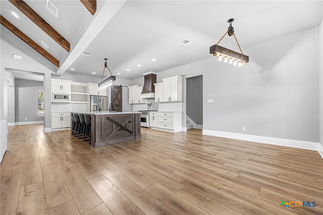 360 Grove Road Killeen, TX 76542 - Photo 12 of 48 a view of a kitchen with cabinets and wooden floor