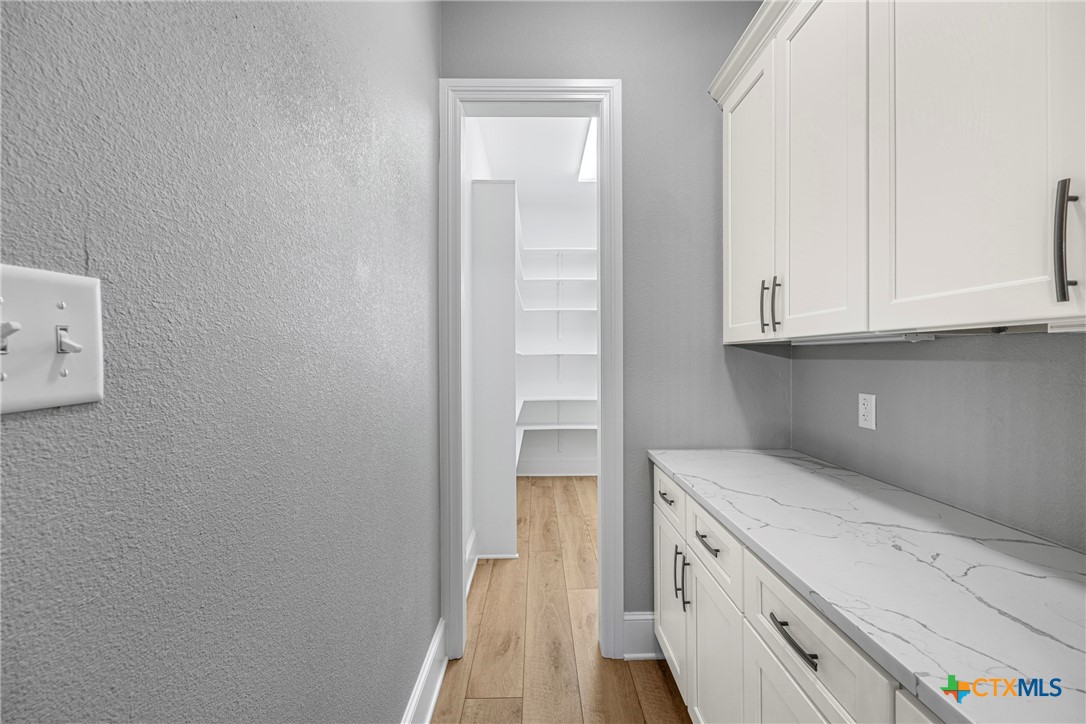 360 Grove Road Killeen, TX 76542 - Photo 18 of 48 a view of cabinets and wooden floor