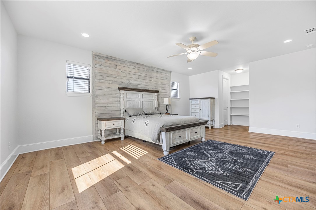 360 Grove Road Killeen, TX 76542 - Photo 19 of 48 a bedroom with a bed and a dresser with wooden floor