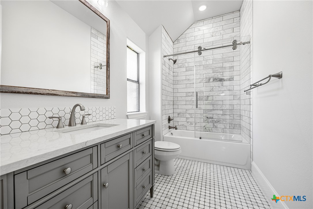 360 Grove Road Killeen, TX 76542 - Photo 29 of 48 a bathroom with a granite countertop sink a toilet and shower