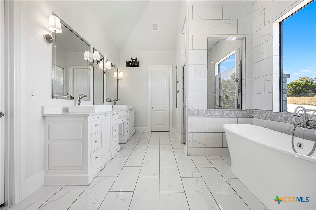 360 Grove Road Killeen, TX 76542 - Photo 35 of 48 a bathroom with a double vanity sink a mirror and a bathtub