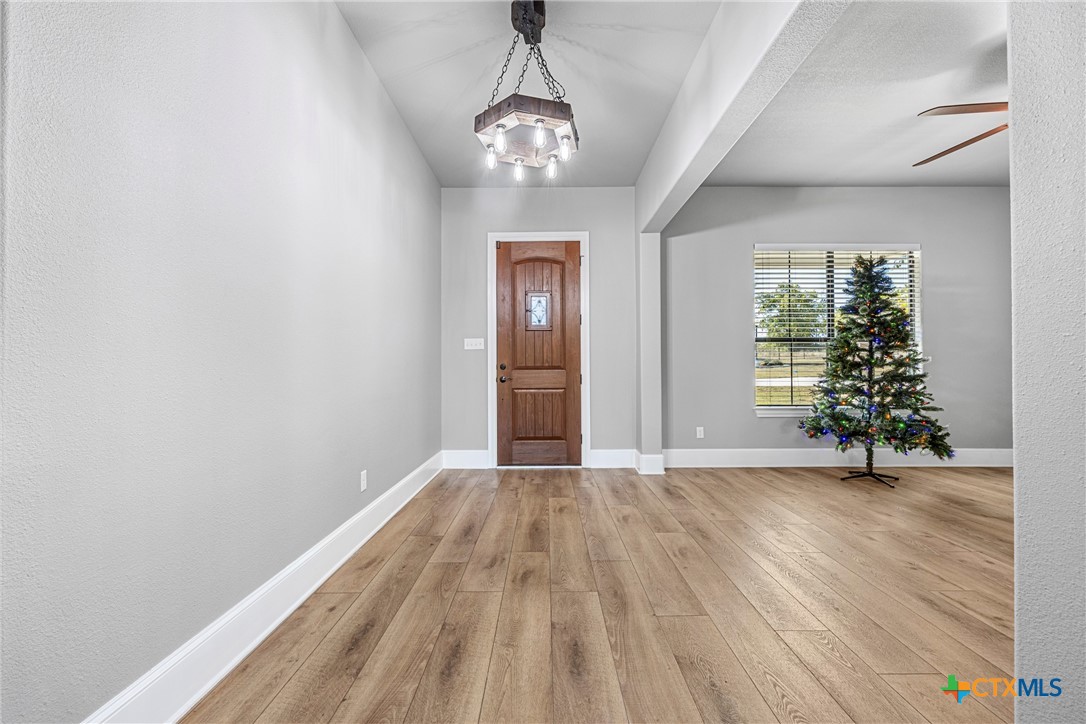 360 Grove Road Killeen, TX 76542 - Photo 6 of 48 a view of an empty room with window and wooden floor