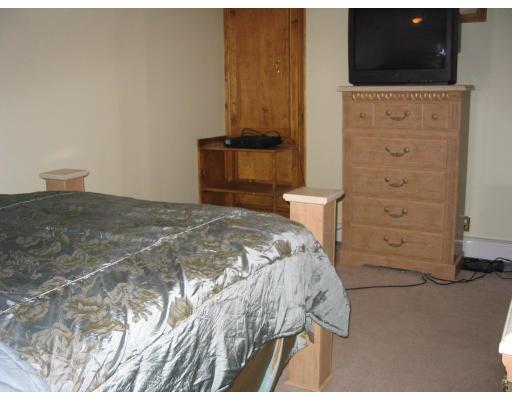 49 Newhall Street Springfield, MA 01109 - Photo 8 of 12 a bedroom with a bed and a television