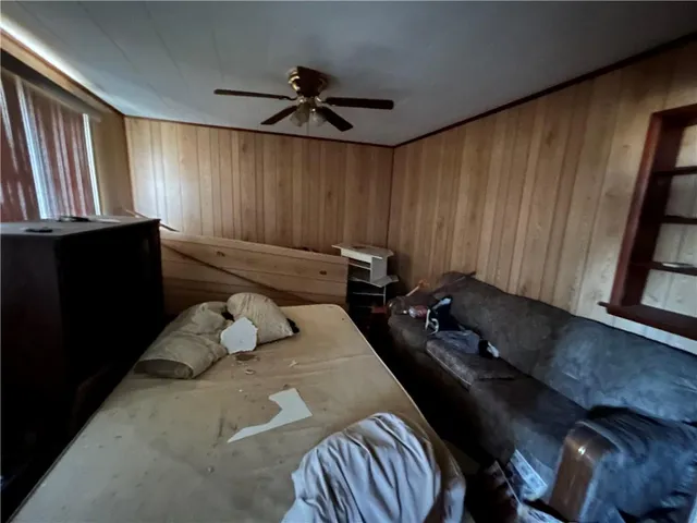 a bedroom with a bed mirror and window