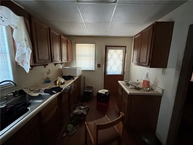 a kitchen with a sink stove and cabinets
