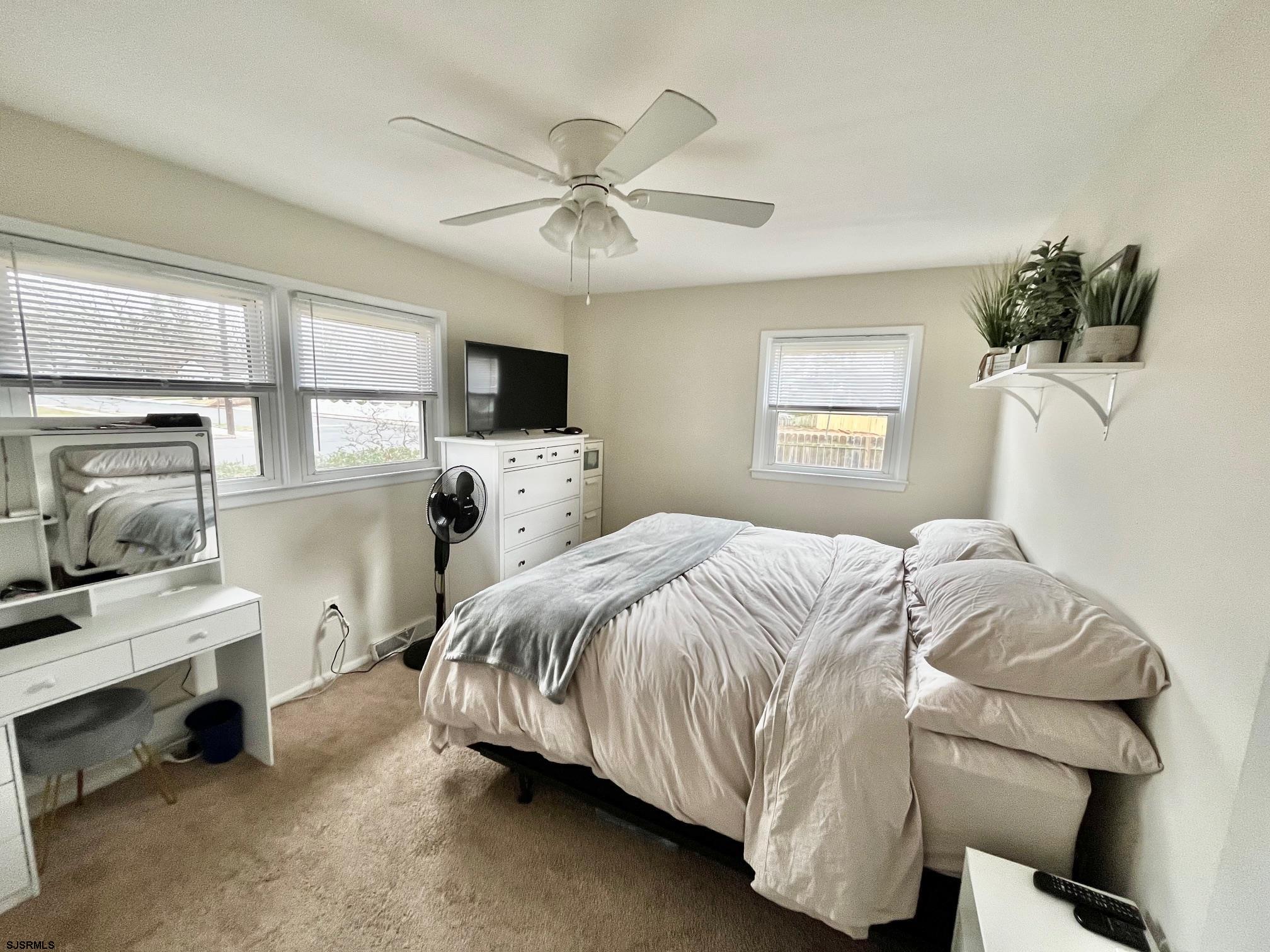415 Rhode Island Avenue Somers Point, NJ 08244 - Photo 13 of 30 a bedroom with a bed and a chandelier