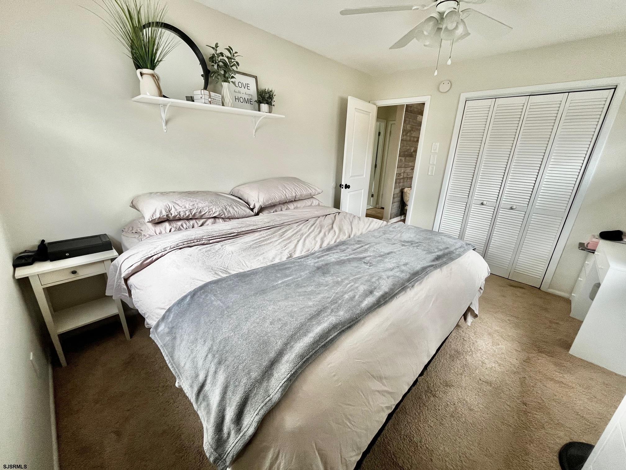 415 Rhode Island Avenue Somers Point, NJ 08244 - Photo 14 of 30 a bedroom with a bed and a dresser