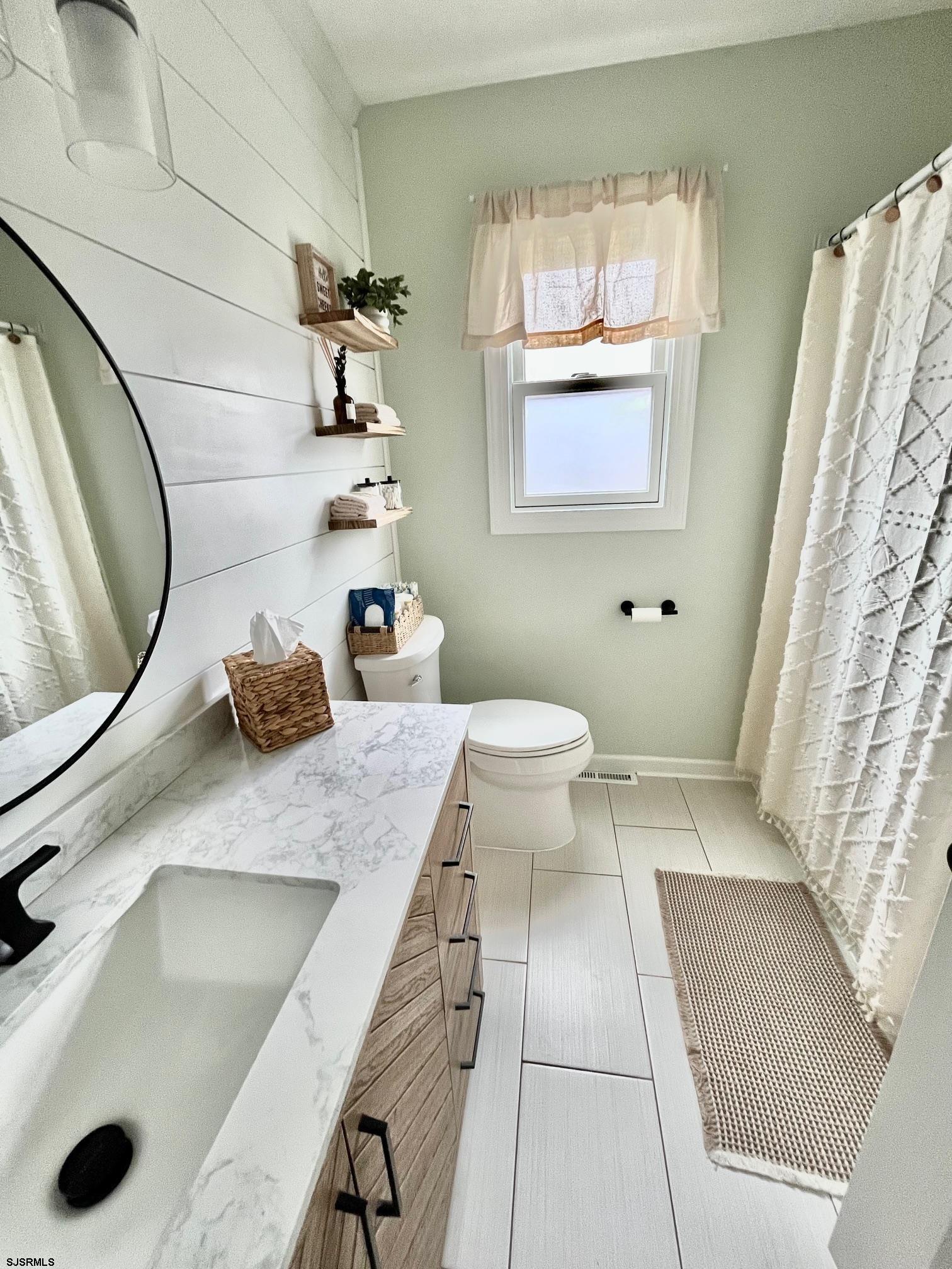 415 Rhode Island Avenue Somers Point, NJ 08244 - Photo 15 of 30 a bathroom with a sink toilet and mirror