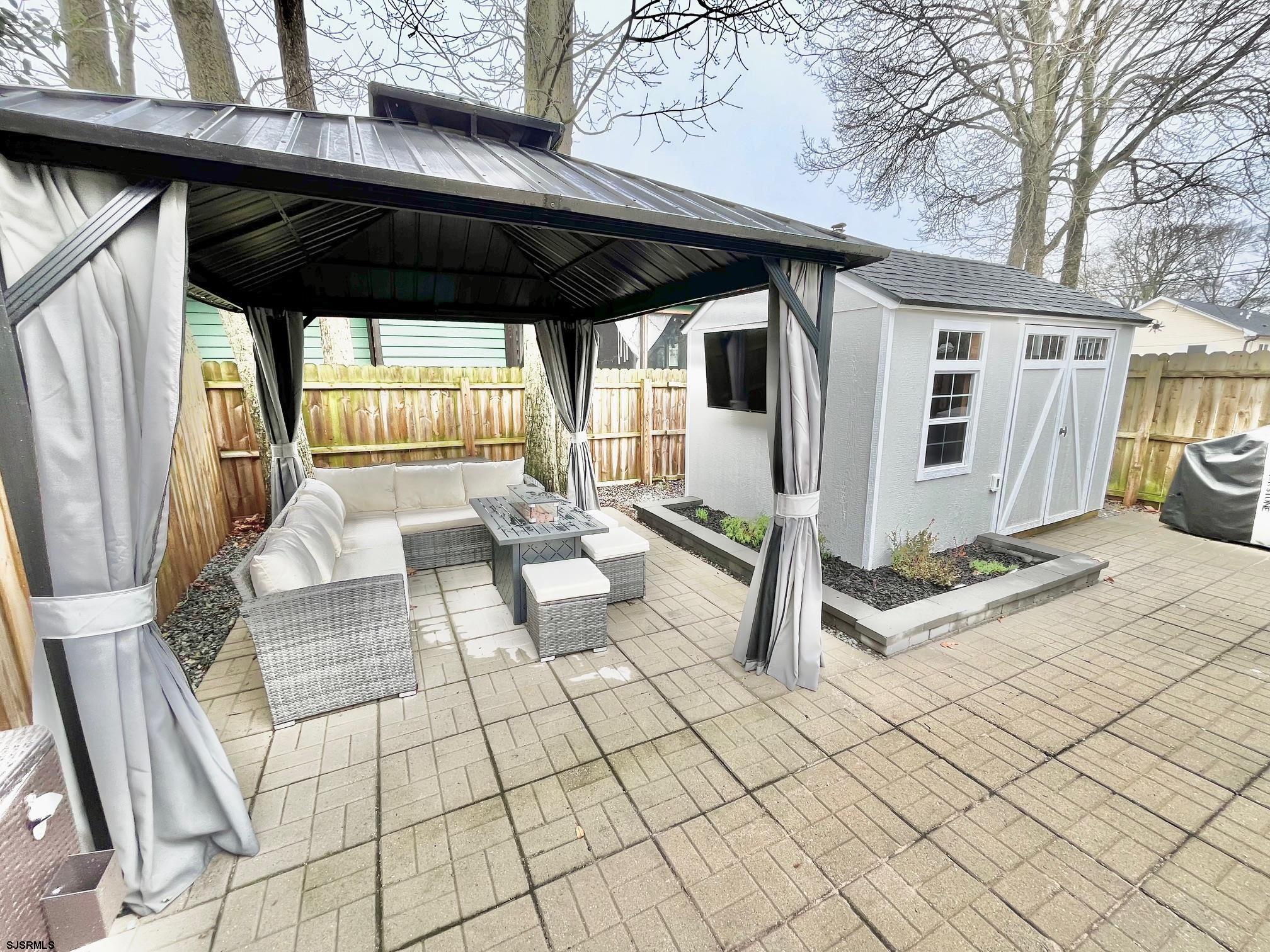 415 Rhode Island Avenue Somers Point, NJ 08244 - Photo 19 of 30 a view of a chairs and table in the patio