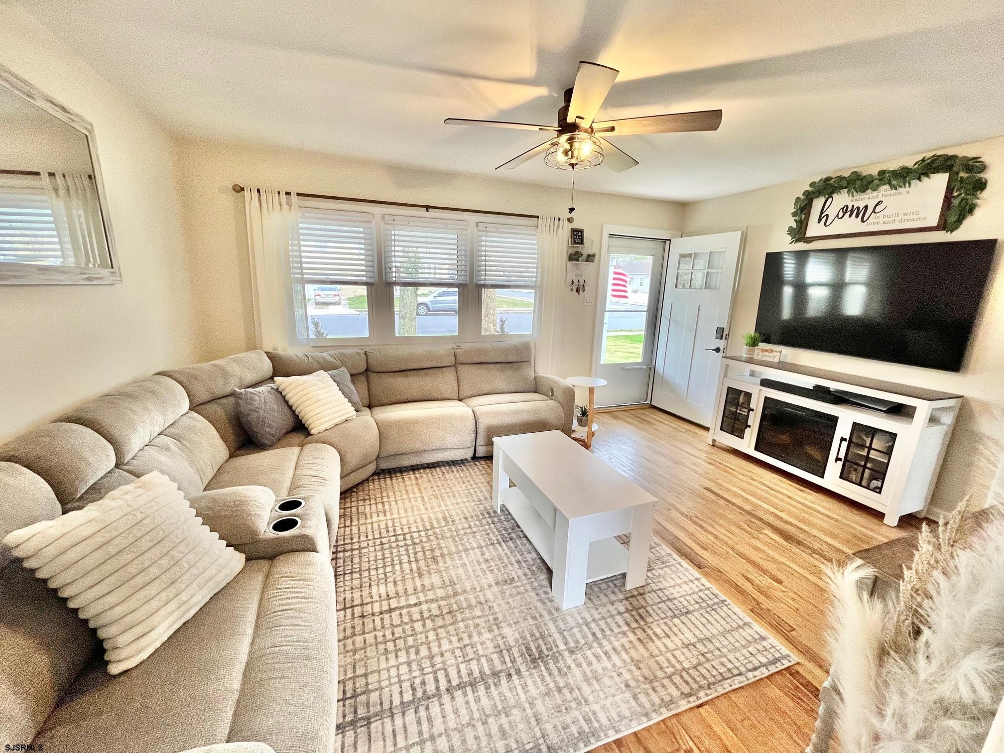 415 Rhode Island Avenue Somers Point, NJ 08244 - Photo 3 of 30 a living room with furniture and a flat screen tv